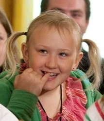 Keywords: girl,smiling,two more steps to finish a portrait,touching teeth,pig tails,green sweater,pink blouse