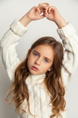 Keywords: girl,kid,child,arms overhead,head tilted,young,long brown hair