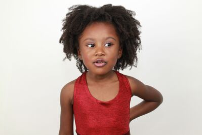 Keywords: attitude,girl,black girl,red t-shirt,arm left hand behind back,short dreadlocks