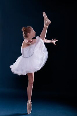 Keywords: girl,woman,youth,young,dancing,dancer,white,ballerina,on point,arabesque,costume,blue background