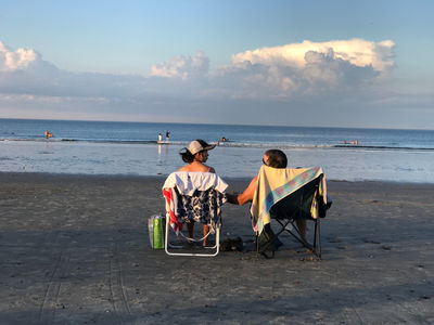 Keywords: beach,couple,evening,sunset,a couple in beach chairs by the ocean