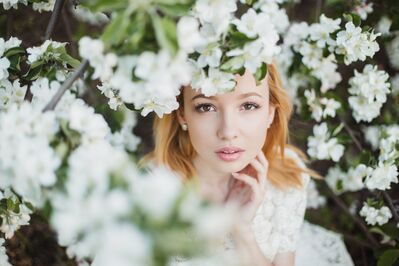 Keywords: young girl,lady,white flowers,looking through branches,light red hair