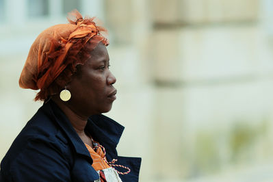 Keywords: black,african,woman,orange,wraper,gold earing,African woman in an orange scarf