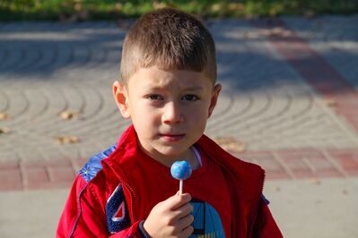 Keywords: portrait,child,kid,children,boy,lollypop,candy,red jacket,class,blue,tiles,pattern