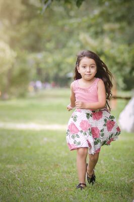 Keywords: portrait,girl,figure,running,pink top,rose covered skirt,grass,trees,park