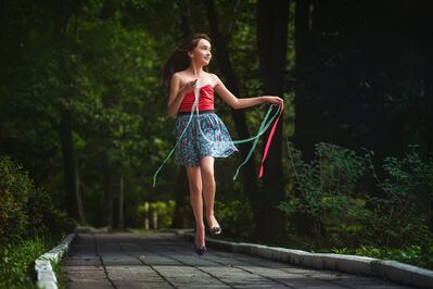 Keywords: portrait,girl,streamers,red top,bare shoulders,blue print skirt,bridge,skipping,wooden,trees,forest