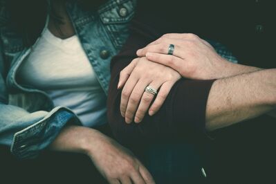 Keywords: hand,hands,holding hand,two people,couple,white t-shirt,blue jacket