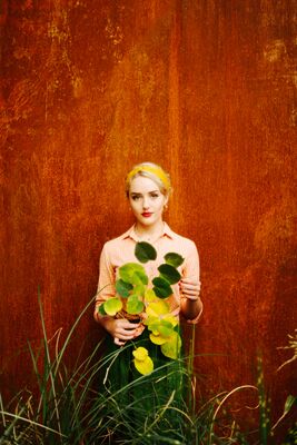 Keywords: girl,portrait,woman,orange wall,green grass,yellow leaves,hair