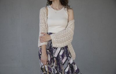 Keywords: body of woman,white top,light brown sweater,print skirt,black and white,hands,arms