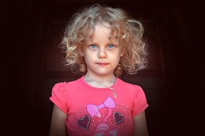 Keywords: portrait,girl,curly blonde,blue eyes,pink shirt,hearts,bows,necklace,gold,cross