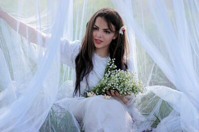 Keywords: girl,woman,youth,young,sheer white curtains,flowers,bouquet,long dark hair,dress