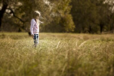 Keywords: girl,standing in field,white top,jeans,trees,grasses