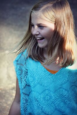 Keywords: girl,blue dress,lacy,orange undershirt,smile,outside,outdoors