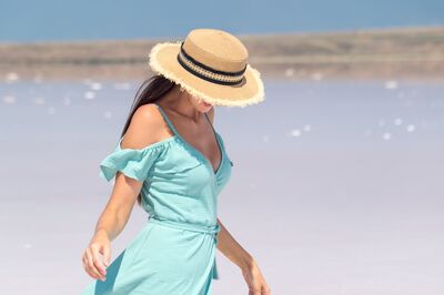 Keywords: beach,ocean,water,woman,walk,hat,blue green dress,straw,black banads,face obscurred,summer,sunny