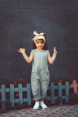 Keywords: portrait,girl,figure,grey jumpsuit,hands,hair scarf,picket fence,blue,brown