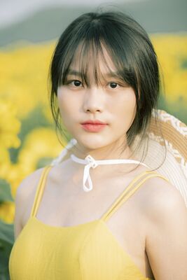 Keywords: girl,woman,youth,young,short black hair,straw hat,yellow dress,sleeveless,straps,flowers,background