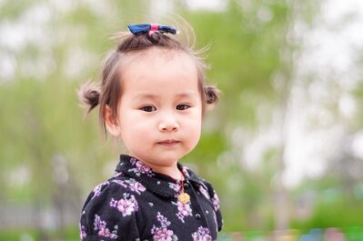 Keywords: girl,child,outdoors,print dress,hair bands,asian,green trees in background