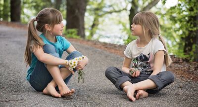 Keywords: girl,girls,youth,young,talking,sitting,bare feet,daisies,blue shirt,white and black shirt,jeans,grey