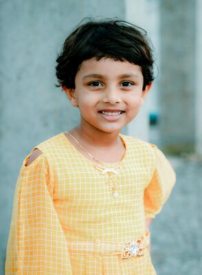 Keywords: girl,kid,child,smiling,yellow dress,short black hair