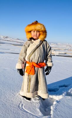 Keywords: child,boy,kid,deel made from skin,short coat,fur cap,red sash,snow,mongol