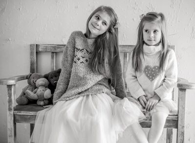 Keywords: girl,kid,child,two bench,teddy bears,sweaters,black and white