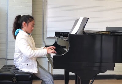 Keywords: a young girl practice piano