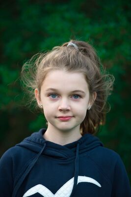 Keywords: girl,kid,child,blue sweatshirt with white seagull,hair up,trees green