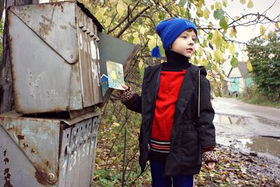 Keywords: boy,red shirt,dark jacket,mailboxes,letter,blue hat with tassel,fall,autumn