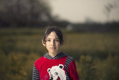 Keywords: portrait,girl,field,top striped with white bear,earrrings,hair up,dark brown