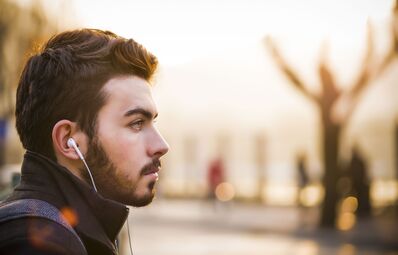 Keywords: man,guy,profile,earbuds,beard,mustache,young,walking,street