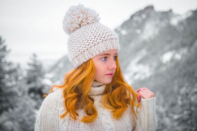 Keywords: girl,white sweater,hat,snow,white mountain,outdoors,winter