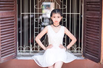 Keywords: girl,bracelet,necklace,earrings,hair up,white costume,shutters,window,youth,young