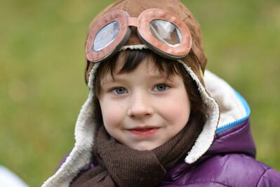 Keywords: portrait,child,kid,children,closeup,bomber jacket,purple,pilot,goggles,tan,hat,hood,outdoors