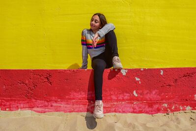 Keywords: girl,woman,youth,young,sit,yellow wall