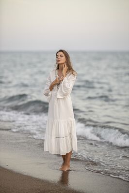 Keywords: girl,woman,youth,young,ocean,beach,whitedress,hands on neck,brown hair