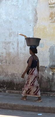 Keywords: woman walking,basket on head,long dress