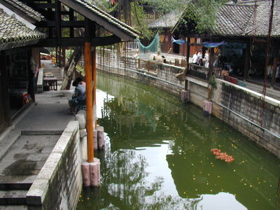 Keywords: green canal,water,small,houses,people