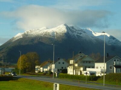 Keywords: mountain,snow,white,buildings,green grass,sunlight