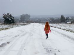 girl-walking-on-snowy-country-road.jpg