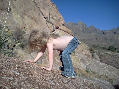 Keywords: child,girl,rock climbing,mountains,mountain,jeans