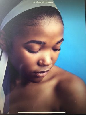 Keywords: brown,woman,closed eyes,blue background,headband white,black