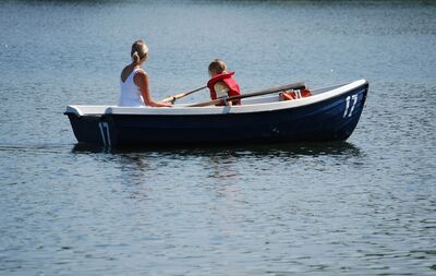 Keywords: Watercolor painting of a rowboat with mom and daughter,river,boat,life jacket