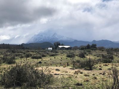 Keywords: white roof,big sky,grey clouds,green foreground