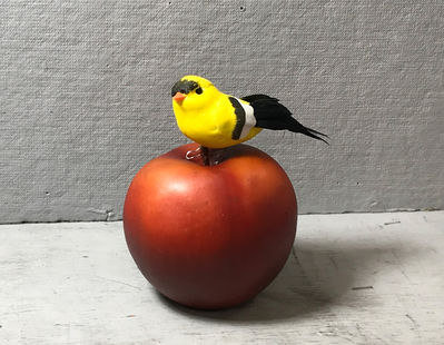 Keywords: Drawing a toy bird sitting on an apple using charcoal,bird,apple,painting a toy bird on top of an apple