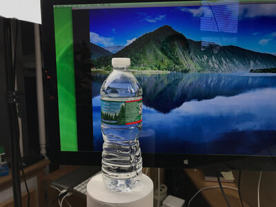 Keywords: water bottle,bottle,view through bottle,drawing a landscape with a bottle of water in front of it using graphite