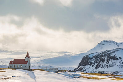 White Cathedral Near Mountain Covered With Snow
